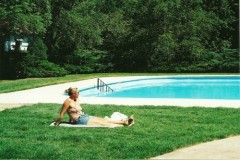 Bather sitting poolside